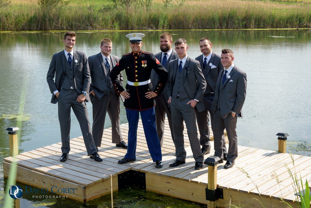 Groomsmen on dock by stream